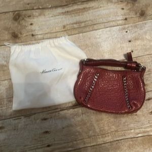 Kenneth Cole brown leather clutch with drawstring bag.